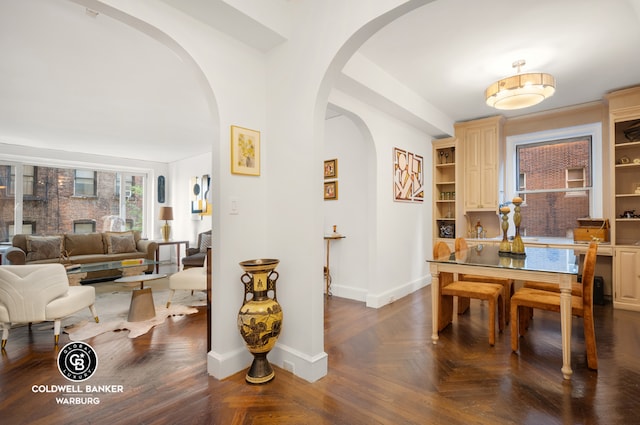 dining room with dark parquet flooring