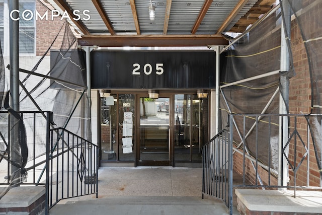 doorway to property with brick siding