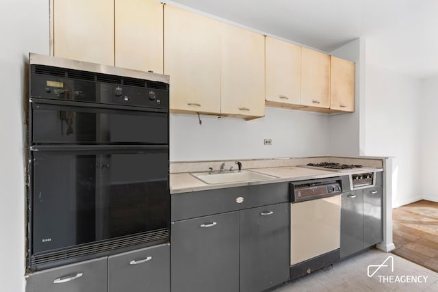185 W End Ave Unit 25H, New York City, NY 10023 - kitchen featuring white dishwasher, black oven, light countertops, cream cabinets, and cooktop