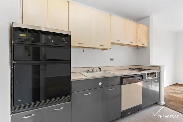 kitchen with stainless steel dishwasher, black double oven, and sink