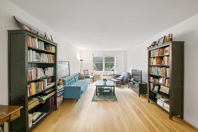 living area with radiator and light wood-type flooring