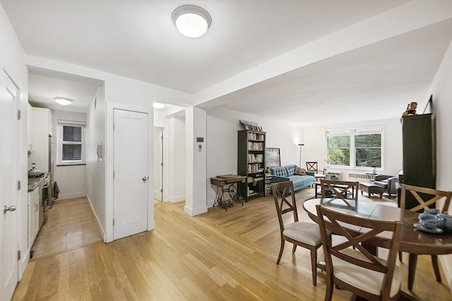 dining room with light wood-style floors and baseboards