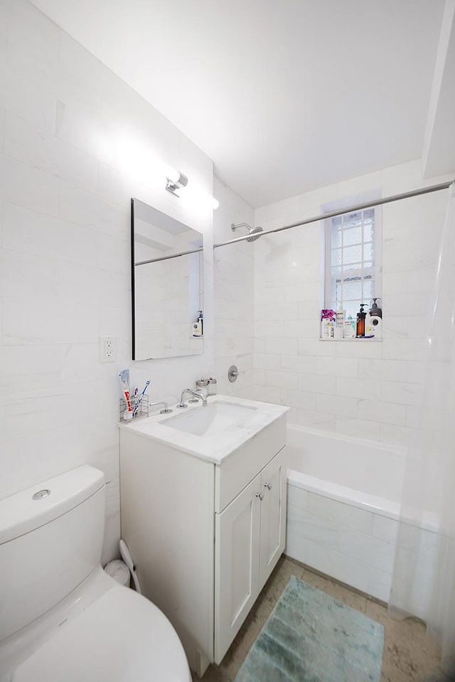 full bath featuring bathing tub / shower combination, tile walls, toilet, and vanity