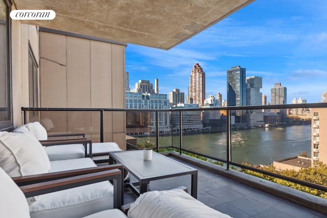 balcony featuring an outdoor living space, visible vents, a view of city, and a water view