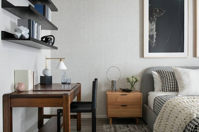 bedroom featuring wallpapered walls, wood finished floors, and baseboards