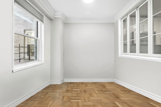 spare room with parquet flooring and ornamental molding