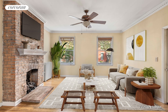 living area with wood finished floors, radiator heating unit, a healthy amount of sunlight, and ornamental molding