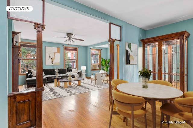 dining area with visible vents, ceiling fan, light wood-style flooring, and ornate columns