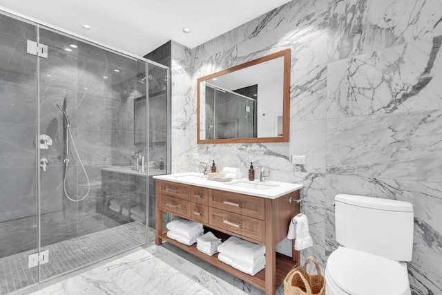 bathroom featuring a shower with door, vanity, and toilet