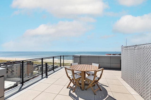 balcony featuring a view of the beach and a water view