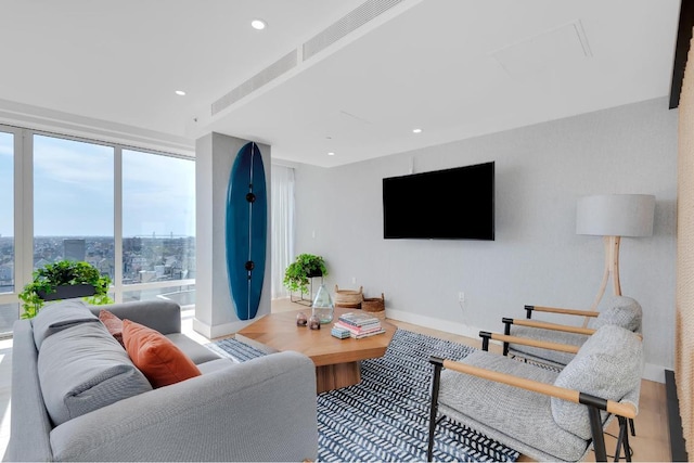 living room with hardwood / wood-style flooring and floor to ceiling windows