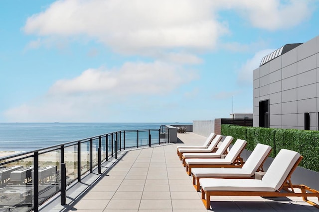 view of patio / terrace featuring a water view and a balcony