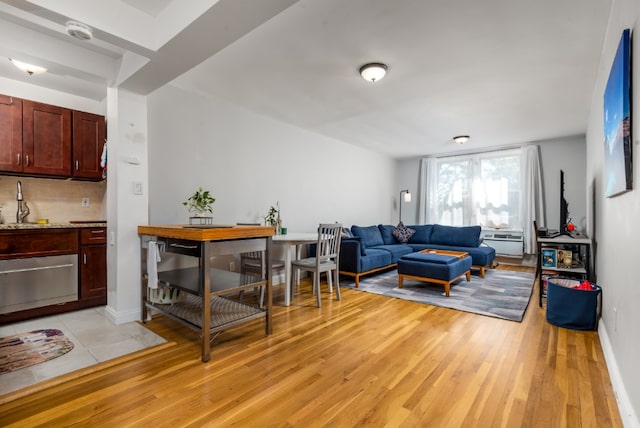 living room featuring light wood-type flooring and baseboards