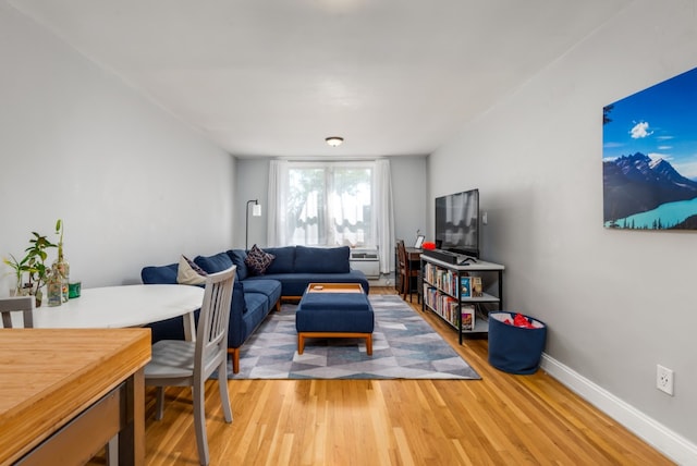 living area featuring baseboards and wood finished floors