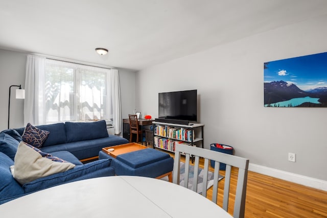 living area with wood finished floors and baseboards