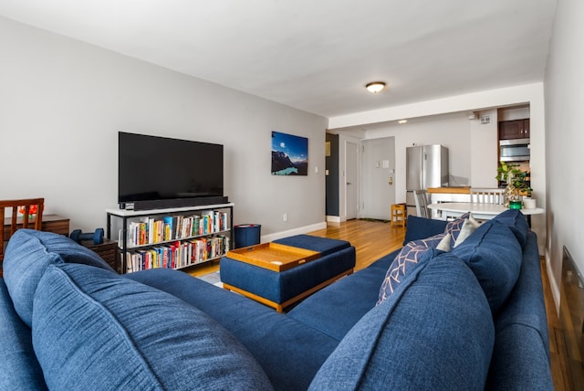 living room with baseboards and wood finished floors