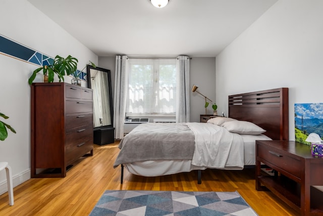 bedroom featuring light wood-style flooring and baseboards