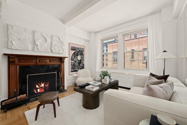 living room with beam ceiling and a fireplace