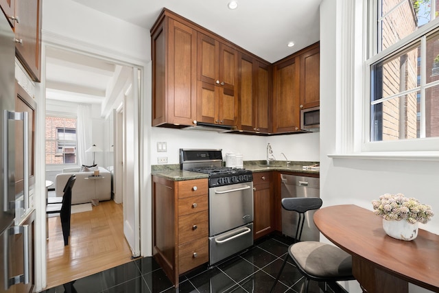 111 E 75th St Phb, Phb, New York City, NY 10021 - kitchen featuring stainless steel appliances, dark stone counters, brown cabinetry, and recessed lighting