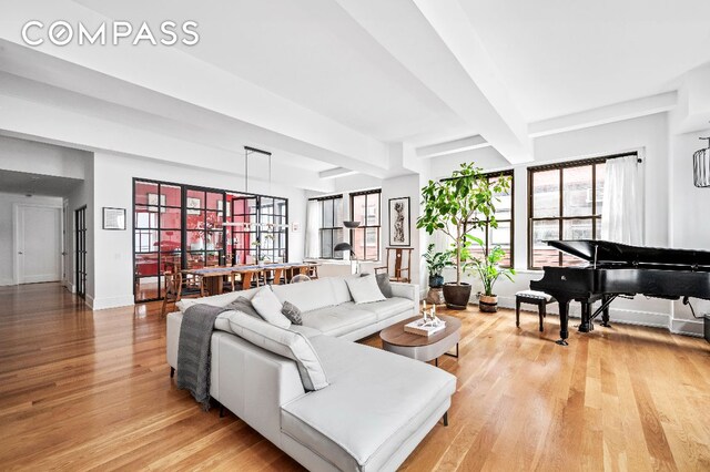 bedroom featuring beam ceiling and hardwood / wood-style floors