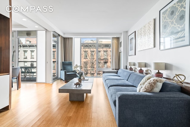 living room with expansive windows and wood finished floors