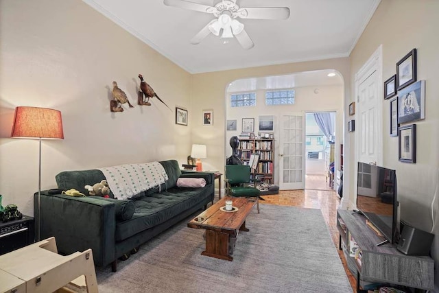 living room featuring crown molding, french doors, and ceiling fan