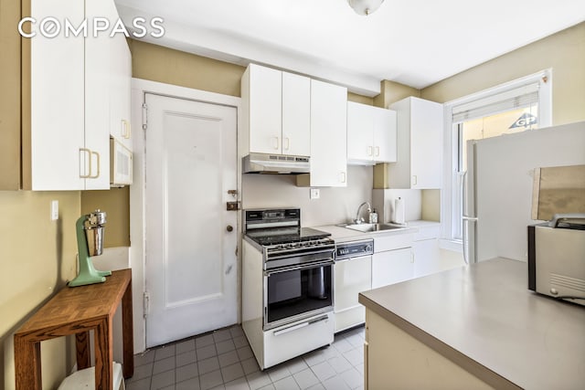 kitchen with white appliances, a sink, light countertops, under cabinet range hood, and white cabinetry