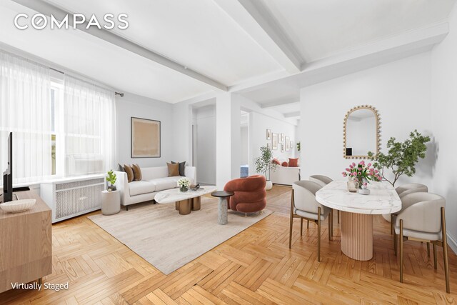 living room featuring light parquet floors, radiator heating unit, and beamed ceiling