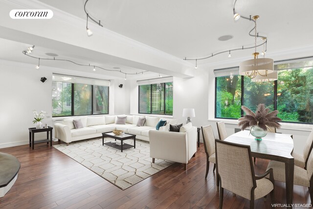 living room with ornamental molding, dark hardwood / wood-style flooring, and a chandelier