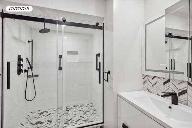 full bath with vanity, backsplash, a shower stall, and visible vents