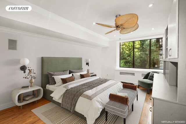 bedroom with ceiling fan, ornamental molding, and light hardwood / wood-style floors