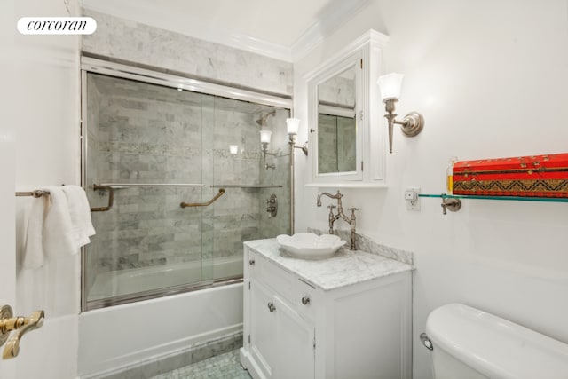 full bathroom featuring vanity, shower / bath combination with glass door, and toilet