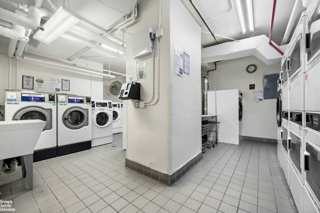 common laundry area featuring independent washer and dryer, stacked washer / drying machine, and tile patterned flooring