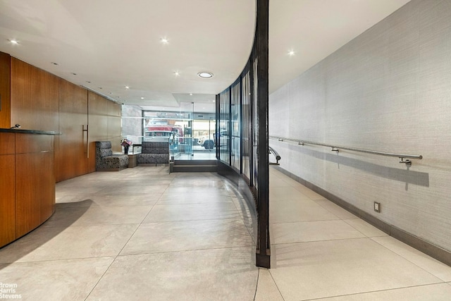 corridor featuring recessed lighting, floor to ceiling windows, and concrete floors