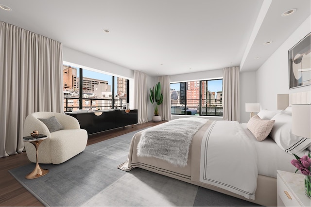 bedroom featuring access to exterior, a city view, recessed lighting, and wood finished floors