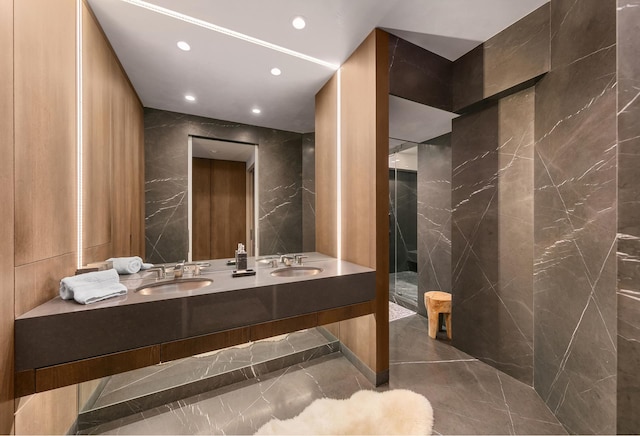 full bathroom featuring a sink, tile walls, recessed lighting, and double vanity