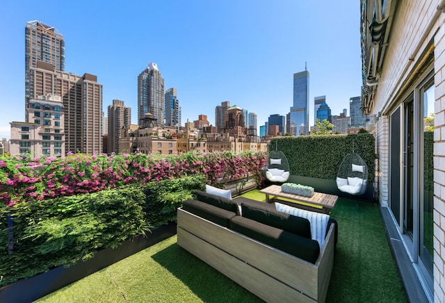 view of patio / terrace featuring a balcony, a city view, and outdoor lounge area