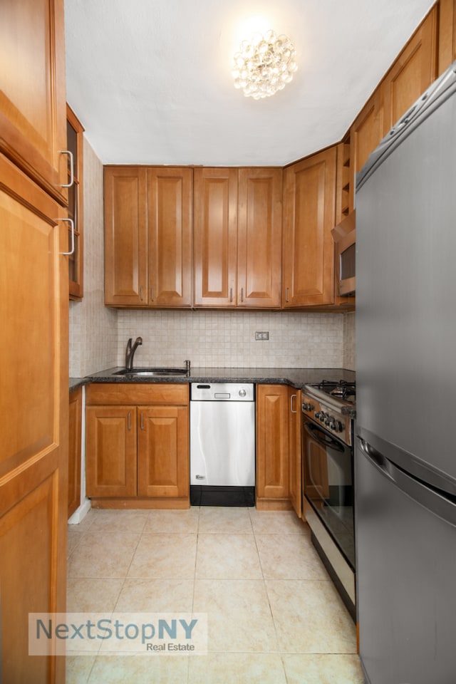 kitchen with appliances with stainless steel finishes and brown cabinetry