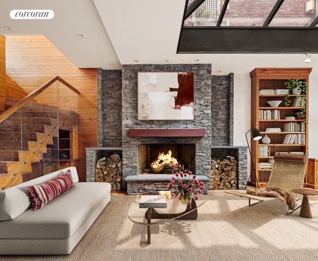 sitting room featuring a stone fireplace and wood walls