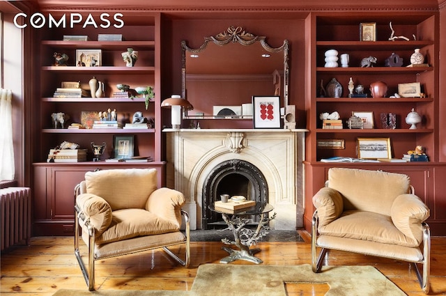 sitting room featuring hardwood / wood-style flooring and radiator heating unit