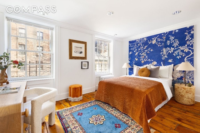 bedroom featuring hardwood / wood-style floors and crown molding