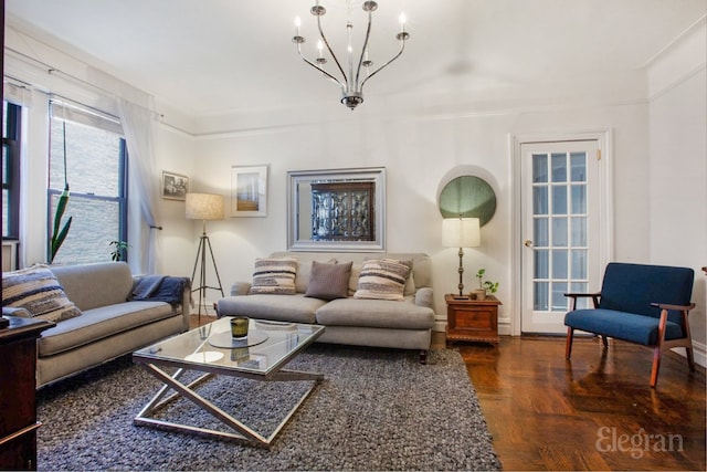 living room with an inviting chandelier and dark hardwood / wood-style floors