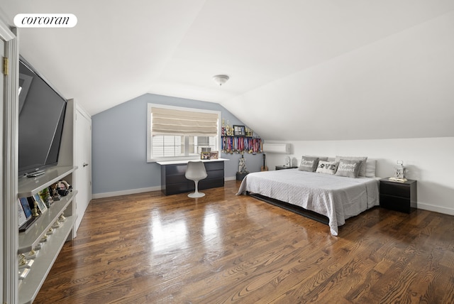 bedroom with vaulted ceiling, an AC wall unit, and dark hardwood / wood-style flooring