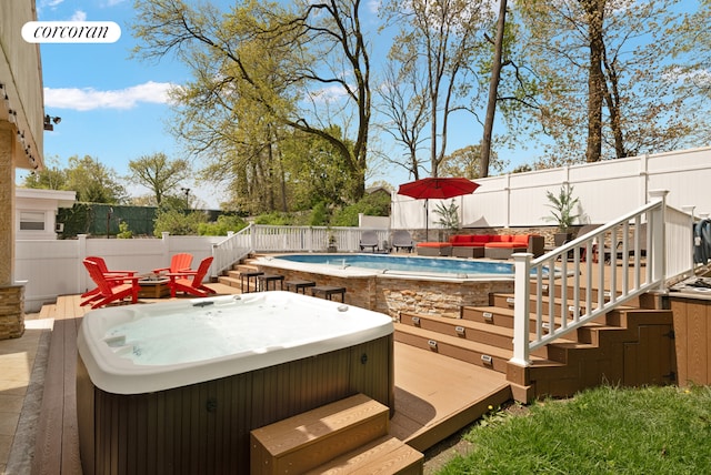 exterior space with a hot tub and a deck