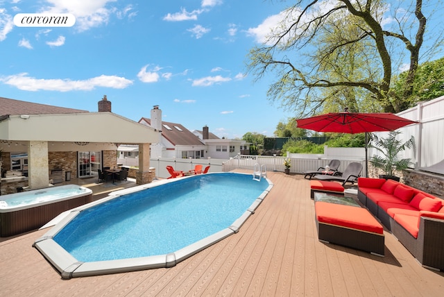 view of swimming pool with an outdoor living space, a hot tub, and a deck