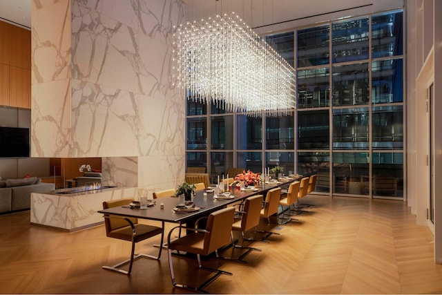 dining room featuring a wall of windows and a notable chandelier