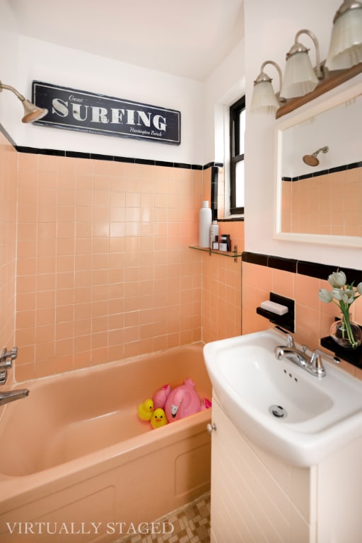 bathroom with vanity, tile walls, and shower / bathtub combination