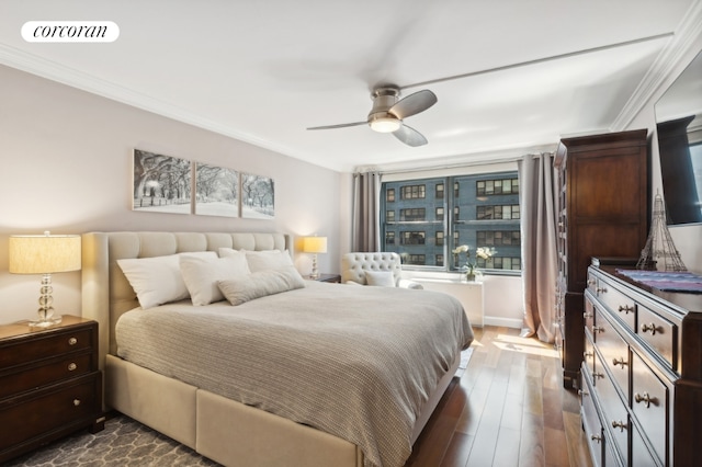 bedroom with ceiling fan, dark hardwood / wood-style flooring, and ornamental molding