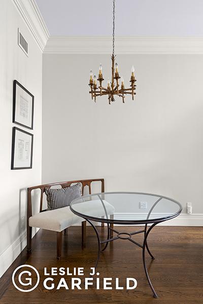 dining area with crown molding, dark wood-type flooring, and an inviting chandelier