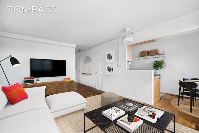 living area featuring baseboards